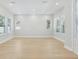 Bright, open living room with multiple windows and wood-look flooring at 214 E Harding St, Orlando, FL 32806