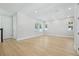 Bright and airy living area with wood floors, large windows, and an open floor plan at 214 E Harding St, Orlando, FL 32806