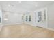 Open living space filled with natural light, featuring wood floors and access to the entryway at 214 E Harding St, Orlando, FL 32806