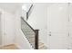 Staircase with wood railing and white risers leading to the upper level at 214 E Harding St, Orlando, FL 32806