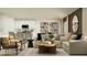 Comfortable living room with sofa, chairs, neutral palette, and is open to the kitchen at 2711 Pioneer Trl, Eagle Lake, FL 33839