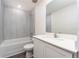 Bright bathroom features a white vanity with modern fixtures, a tub, and decorative light-colored wall tiles at 3817 Corsican Pl, Lake Alfred, FL 33850