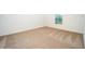 Bedroom with wall-to-wall carpeting and a view to the yard at 3817 Corsican Pl, Lake Alfred, FL 33850