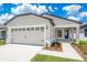 Charming single-story home with a two-car garage, covered entry and well manicured lawn at 3817 Corsican Pl, Lake Alfred, FL 33850