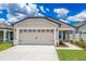 Charming single-story home with a two-car garage, covered entry and well manicured lawn at 3817 Corsican Pl, Lake Alfred, FL 33850