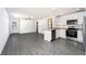 Open floor plan with stainless steel appliances and ample counter space at 3817 Corsican Pl, Lake Alfred, FL 33850