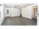 Spacious living room area with a ceiling fan and an adjacent kitchen at 3817 Corsican Pl, Lake Alfred, FL 33850