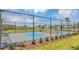 Outdoor pickleball court with a chain-link fence and new construction homes in the background at 4670 Yellow Elder Way, Kissimmee, FL 34758