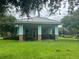 A beautiful community cabana with picnic tables and a grassy lawn at 7071 Spring Park Dr, Winter Garden, FL 34787