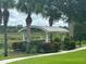 A beautiful community gazebo surrounded by lush greenery with views of the lake at 7071 Spring Park Dr, Winter Garden, FL 34787
