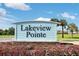 Lakeview Pointe community sign surrounded by beautiful flowers and palm trees on a sunny day at 7071 Spring Park Dr, Winter Garden, FL 34787