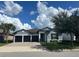 Charming single-story home with a manicured lawn, paver driveway, and a two-car garage at 7071 Spring Park Dr, Winter Garden, FL 34787