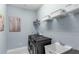 Laundry room features modern washer and dryer, shelving for storage, and a utility sink at 7071 Spring Park Dr, Winter Garden, FL 34787