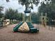 Community playground with climbing structure and slides for residents to enjoy at 7071 Spring Park Dr, Winter Garden, FL 34787