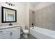 Full bathroom with tub and shower combo with gray tile and a white vanity with granite top at 7740 Somersworth Dr, Kissimmee, FL 34747