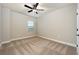 Bright bedroom with neutral paint and carpet, ceiling fan, and a large window at 7740 Somersworth Dr, Kissimmee, FL 34747