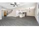 Open-concept living room and kitchen area with gray wood flooring and natural light at 7740 Somersworth Dr, Kissimmee, FL 34747