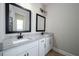 Bathroom featuring double sinks, granite countertops, and framed mirrors at 7869 Somersworth Dr, Kissimmee, FL 34747