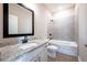 Bathroom features a tub, shower, granite countertops, and modern fixtures at 7869 Somersworth Dr, Kissimmee, FL 34747