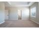 Bright bedroom showcases plush carpeting, neutral walls, and a large window with natural light at 7869 Somersworth Dr, Kissimmee, FL 34747