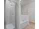 Bathroom featuring a glass shower and a soaking tub at 385 Begonia Ct, Poinciana, FL 34759