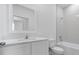 Bathroom with a white vanity, toilet, and shower and tub combination at 385 Begonia Ct, Poinciana, FL 34759