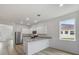 Bright kitchen features white cabinets, stainless steel appliances and granite countertops at 385 Begonia Ct, Poinciana, FL 34759