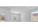 A brightly lit living room with wood-look floors, a front door, and a window at 385 Begonia Ct, Poinciana, FL 34759