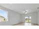 A brightly lit living room with sliding glass doors and a ceiling fan at 385 Begonia Ct, Poinciana, FL 34759
