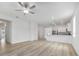 Open-concept living room with wood-look flooring and seamless flow to the kitchen at 385 Begonia Ct, Poinciana, FL 34759