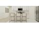 Bright kitchen featuring an island with seating and white cabinetry at 1292 Blue Ash Ln, Deland, FL 32720
