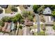 Aerial view showcasing home's layout, roof, driveway and verdant landscaping in a mature neighborhood at 132 Margate Mews, Longwood, FL 32779