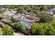 Aerial view showing fenced pool and surrounding greenery and landscaping at 132 Margate Mews, Longwood, FL 32779