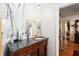 Bathroom features an ornate mirror, dark granite sink top, and bright marble tiling at 132 Margate Mews, Longwood, FL 32779