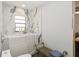 Bright bathroom featuring marble accent wall, tiled floors, and accessible tub at 132 Margate Mews, Longwood, FL 32779