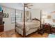 Spacious bedroom features a four-poster bed, hardwood floors, and seaside themed decor at 132 Margate Mews, Longwood, FL 32779