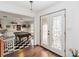 View of the entrance with detailed glass doors, hardwood flooring and a game room with a billiards table at 132 Margate Mews, Longwood, FL 32779