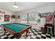 Spacious game room with pool table, black and white checkered floors, and Coca-Cola themed decor at 132 Margate Mews, Longwood, FL 32779