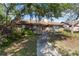 Charming brick home with a well-maintained lawn and pathway to front door at 132 Margate Mews, Longwood, FL 32779
