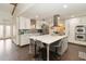 Beautiful, updated kitchen featuring an island with seating, modern appliances, and an open floor plan at 132 Margate Mews, Longwood, FL 32779