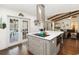 Modern kitchen island with stainless hood, hardwood floors, and view to the outdoor pool at 132 Margate Mews, Longwood, FL 32779