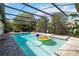 Inviting screened-in pool with clear blue water, complete with colorful inflatable toys and lounge chairs at 132 Margate Mews, Longwood, FL 32779