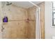 Tiled shower with built-in shelving and neutral tones, creating a clean and functional space for personal care at 132 Margate Mews, Longwood, FL 32779