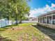 Spacious backyard featuring a white privacy fence, mature trees, and an enclosed sunroom at 2376 Home Again Rd, Apopka, FL 32712