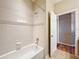 This bathroom has a tile surround shower, door and tile flooring at 2376 Home Again Rd, Apopka, FL 32712
