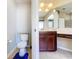 This bathroom features a toilet, vanity with drawers and a large mirror at 2376 Home Again Rd, Apopka, FL 32712