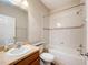 This bathroom has a vanity, toilet and shower with a tile surround at 2376 Home Again Rd, Apopka, FL 32712