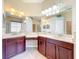 Lavish bathroom featuring double sinks, a vanity area, and decorative mirrors at 2376 Home Again Rd, Apopka, FL 32712