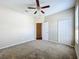 This is an unfurnished bedroom with a ceiling fan, closet and neutral carpet at 2376 Home Again Rd, Apopka, FL 32712