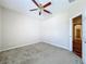 This unfurnished bedroom features a ceiling fan, carpet and base molding at 2376 Home Again Rd, Apopka, FL 32712